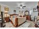Spacious main bedroom with elegant furniture, ceiling fan, and neutral decor at 822 Sheen Cir, Haines City, FL 33844