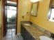 Bathroom vanity with double sinks, granite countertops, and modern fixtures, next to the glass enclosed shower at 872 Huckleberry Ln, Winter Springs, FL 32708