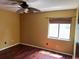 Cozy bedroom with wood floors, ceiling fan, and a window providing natural light at 872 Huckleberry Ln, Winter Springs, FL 32708