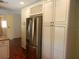 Bright kitchen boasts stainless steel refrigerator and ample white cabinetry with wine rack at 872 Huckleberry Ln, Winter Springs, FL 32708