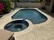 Inviting in-ground pool with an attached jacuzzi spa and serene backyard view at 872 Huckleberry Ln, Winter Springs, FL 32708