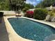 Sparkling in-ground pool featuring a sun deck and lush backyard landscaping at 872 Huckleberry Ln, Winter Springs, FL 32708