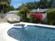 Backyard pool with jacuzzi, lounge chairs, and mature landscaping for privacy at 872 Huckleberry Ln, Winter Springs, FL 32708
