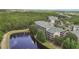 Aerial view of residences nestled near a peaceful lake and lush forest at 9055 Treasure Trove Ln # 501, Kissimmee, FL 34747