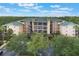 Apartment community amid lush trees boasts manicured landscaping and ample parking at 9055 Treasure Trove Ln # 501, Kissimmee, FL 34747