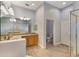 Bright bathroom featuring a dual sink vanity, walk-in shower, and private toilet room at 9055 Treasure Trove Ln # 501, Kissimmee, FL 34747