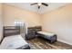 Shared bedroom with matching beds, dark wood floors, and natural light at 9055 Treasure Trove Ln # 501, Kissimmee, FL 34747