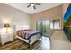 Bright bedroom features a ceiling fan, nice balcony view, and wood-look flooring at 9055 Treasure Trove Ln # 501, Kissimmee, FL 34747