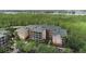 Expansive view of the condos with a treeline and body of water in the background at 9055 Treasure Trove Ln # 501, Kissimmee, FL 34747