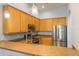 Well-equipped kitchen showcasing stainless appliances and efficient layout with breakfast bar at 9055 Treasure Trove Ln # 501, Kissimmee, FL 34747