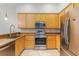 Functional kitchen features stainless appliances, ample storage, and light wood cabinets at 9055 Treasure Trove Ln # 501, Kissimmee, FL 34747