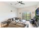 Comfortable living room featuring a large sectional sofa, balcony access, and wood-look floors at 9055 Treasure Trove Ln # 501, Kissimmee, FL 34747