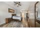 Serene main bedroom with wood-style floors, neutral decor, and ensuite access at 9055 Treasure Trove Ln # 501, Kissimmee, FL 34747