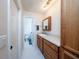 Bathroom featuring wood cabinets, a granite countertop, and an open doorway into another bathroom at 10108 Matchlock Dr, Orlando, FL 32821
