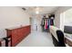 Bright bedroom with ceiling fan, closet rack, wood dresser, tile floors, and natural light at 10108 Matchlock Dr, Orlando, FL 32821