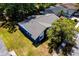 An overhead view showcases a blue home featuring a gray tiled roof and mature landscaping at 10108 Matchlock Dr, Orlando, FL 32821