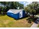 Aerial view of a charming blue and white accented home with a well-maintained lawn at 10108 Matchlock Dr, Orlando, FL 32821