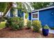 Inviting front entrance featuring a bright yellow door and lush landscaping at 10108 Matchlock Dr, Orlando, FL 32821