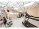 Modern gym with a variety of exercise equipment, tile flooring, and good lighting at 10108 Matchlock Dr, Orlando, FL 32821