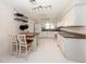 Bright kitchen with white cabinetry, track lighting, and a center island with seating at 10108 Matchlock Dr, Orlando, FL 32821