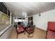 Enclosed back porch with dining table and chairs, red lounge chair, and privacy from the sun at 10108 Matchlock Dr, Orlando, FL 32821