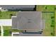 Aerial view of the home showcasing a modern roof, manicured landscaping, and a spacious driveway at 1105 Grand Hammock Ct, Kissimmee, FL 34746