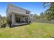Lush backyard featuring a covered patio and a privacy fence, offering an ideal outdoor living space at 1105 Grand Hammock Ct, Kissimmee, FL 34746