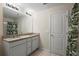Well-lit bathroom boasts a double vanity with granite countertops and modern fixtures at 1105 Grand Hammock Ct, Kissimmee, FL 34746