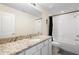 Bright bathroom features a granite vanity, modern fixtures, and a combined tub and shower at 1105 Grand Hammock Ct, Kissimmee, FL 34746