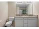 Elegant bathroom featuring double sinks with granite countertops and modern fixtures at 1105 Grand Hammock Ct, Kissimmee, FL 34746