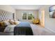 Comfortable bedroom with a plush bed, natural light, and a cozy reading nook at 1105 Grand Hammock Ct, Kissimmee, FL 34746