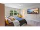 Well-lit bedroom with large windows, a TV, and a cozy yellow chair at 1105 Grand Hammock Ct, Kissimmee, FL 34746