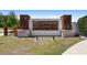 Elegant community sign featuring stacked wood pillars and stone bases, enhancing the neighborhood's entrance at 1105 Grand Hammock Ct, Kissimmee, FL 34746