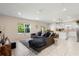 Bright, open-concept living room features a sectional sofa, tile floors, and abundant natural light at 1105 Grand Hammock Ct, Kissimmee, FL 34746