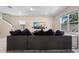Open living room featuring a large sectional sofa and entertainment center with a wall-mounted television at 1105 Grand Hammock Ct, Kissimmee, FL 34746