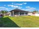 Spacious backyard with well-maintained lawn, covered patio, and privacy fencing at 112 Red Maple Burl Cir, Debary, FL 32713