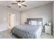 Comfortable bedroom featuring soft bedding, neutral tones, ceiling fan, and natural light at 112 Red Maple Burl Cir, Debary, FL 32713