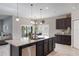 Bright, modern kitchen featuring a large island, stainless steel appliances, and seamless flow to the dining area at 112 Red Maple Burl Cir, Debary, FL 32713