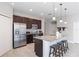 Modern kitchen with granite countertops, stainless steel appliances, and a large island with seating at 112 Red Maple Burl Cir, Debary, FL 32713