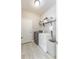 Practical laundry room featuring a washer, dryer, shelving, and tiled flooring at 112 Red Maple Burl Cir, Debary, FL 32713