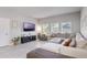 Cozy living room with neutral colors, ample seating, and bright windows at 112 Red Maple Burl Cir, Debary, FL 32713