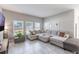 Comfortable living room with neutral decor, large sectional sofa, and natural light from the windows at 112 Red Maple Burl Cir, Debary, FL 32713