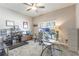 Well-lit home office featuring a glass desk, modern decor, and neutral color palette at 112 Red Maple Burl Cir, Debary, FL 32713