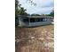 Exterior view of the home showing the back of the home with vinyl siding and an enclosed porch at 1238 Lakecrest Dr, Apopka, FL 32703