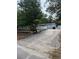 Charming single-story home featuring a long driveway, mature trees, and a well-maintained yard with a picket fence at 1238 Lakecrest Dr, Apopka, FL 32703