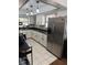 Kitchen with stainless steel appliances, white cabinets, and neutral tile flooring at 1238 Lakecrest Dr, Apopka, FL 32703
