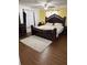 Luxurious main bedroom with hardwood floors, and an elegant bed with matching furniture at 1238 Lakecrest Dr, Apopka, FL 32703