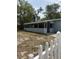 The back of the home shows an enclosed porch and white picket fencing at 1238 Lakecrest Dr, Apopka, FL 32703
