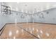 Indoor basketball court featuring well-maintained hardwood floors and multiple hoops at 12843 Madison Pointe Cir # 106, Orlando, FL 32821