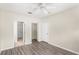 Spacious bedroom featuring wood-look floors, ceiling fan, closet, and ensuite at 12843 Madison Pointe Cir # 106, Orlando, FL 32821